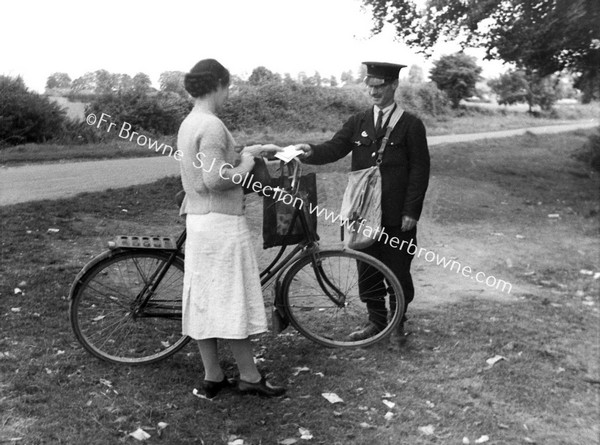 LADY CYCLIST MEETS POSTMAN